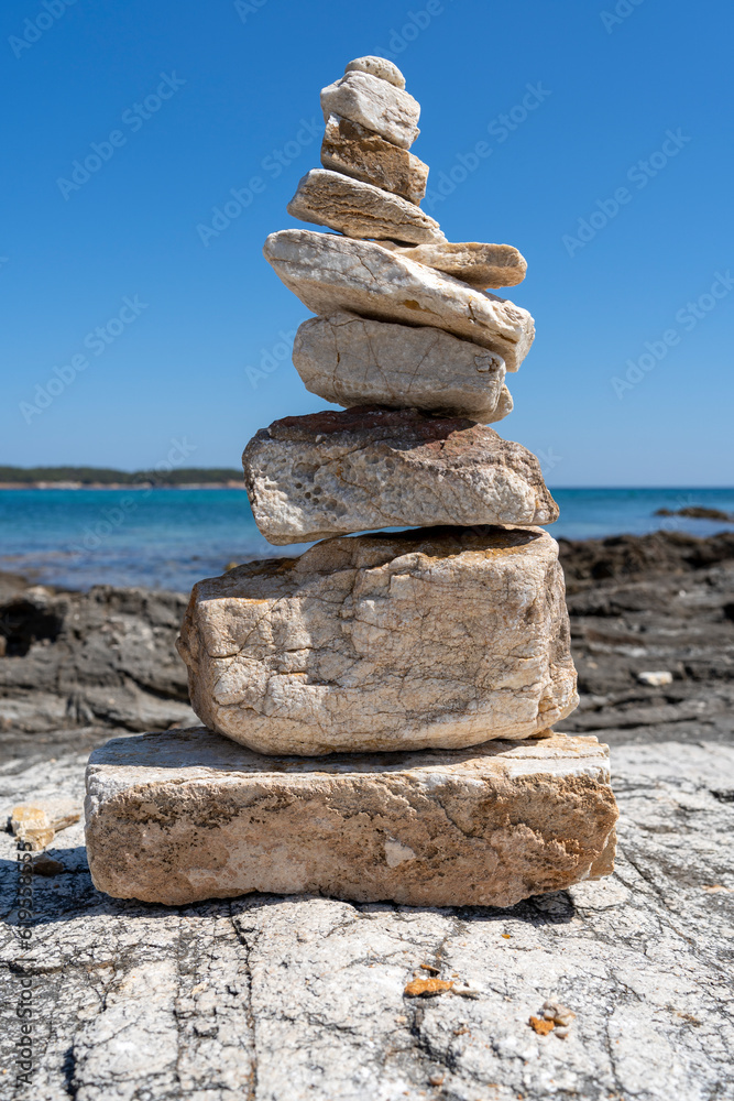 Stacked stones on a rocky beach in the Aegean sea Stacked stones on a rocky beach in the Aegean sea