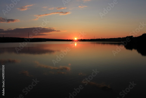 A sunset over a lake © parpalac