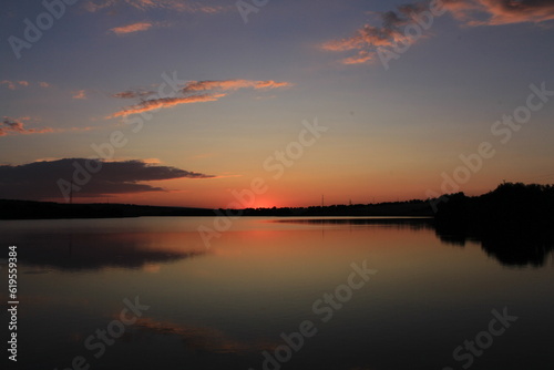 A sunset over a lake © parpalac