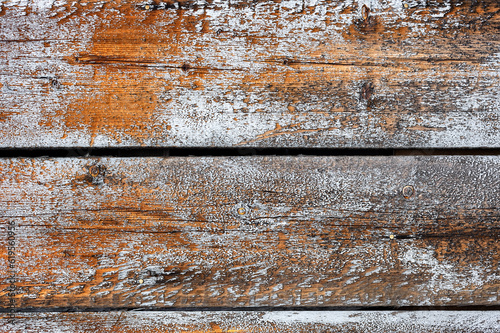 Texture of weathered wooden boards with traces of old paint.