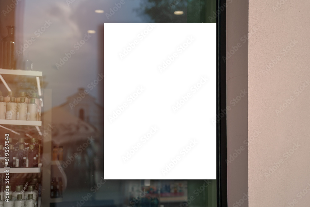 White vertical banner fixed on pharmacy or cosmetics store window glass outside White vertical banner fixed on pharmacy or cosmetics store window glass outside
