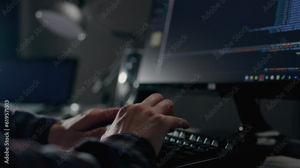 A professional programmer works remotely in a home office, writes code to create software from the comfort of his home on his laptop computer. remote work for freelancer IT technology
