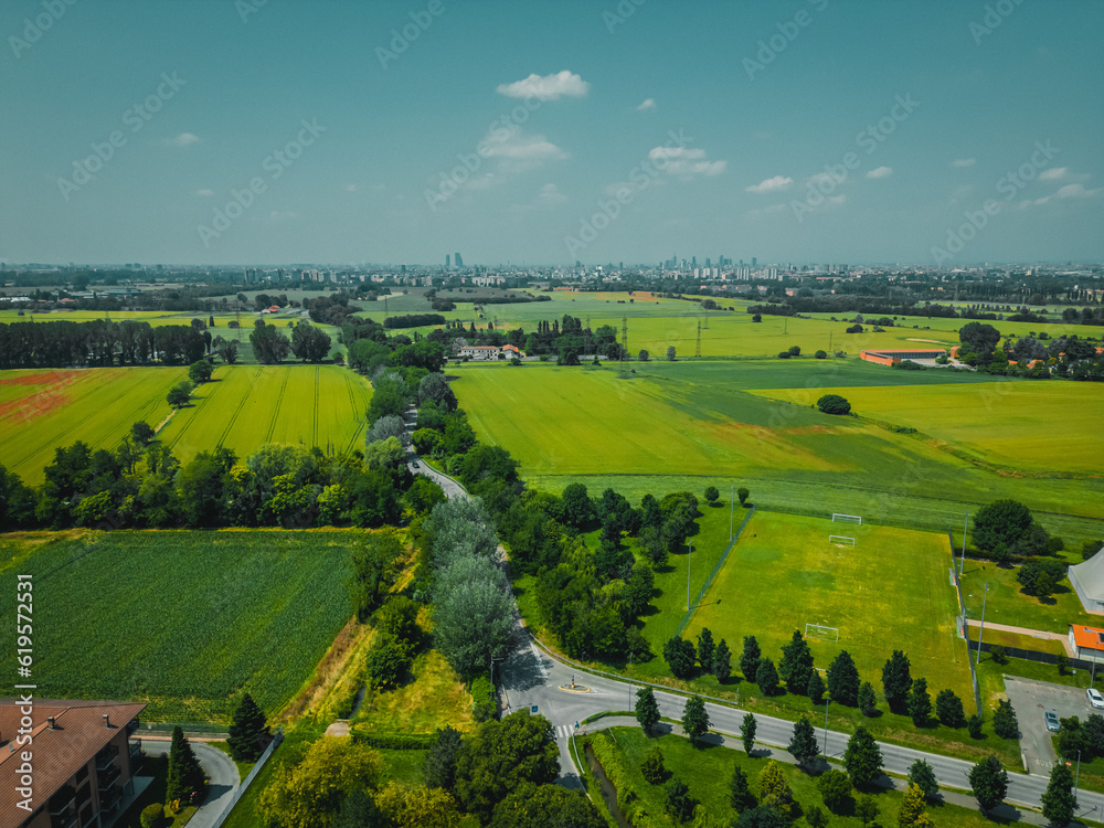Green fields and rural road in Lombardy region, Italy