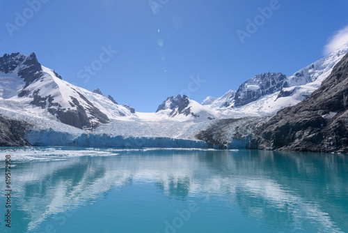 View of snow covered mountains with jagged peaks and floating ice at South Georgia Island's Drygalski Fjord