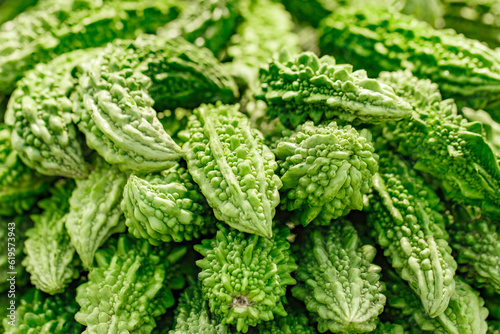 Momordica cucumber bitter gourd sell vegetables in market, selective focus