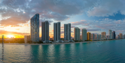 High angle view of Sunny Isles Beach city at sunset with expensive highrise hotels and condo buildings over beachfront on Atlantic shore. American tourism infrastructure in coastal southern Florida © bilanol