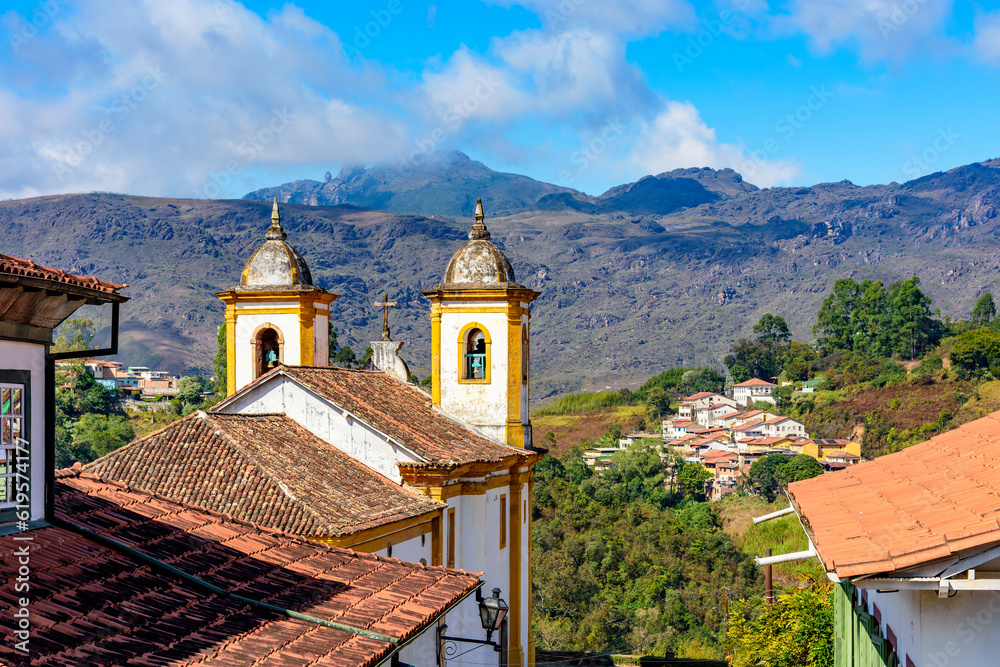 Ancient colorful baroque church with mountains in the background in Ouro Preto city in Minas Gerais