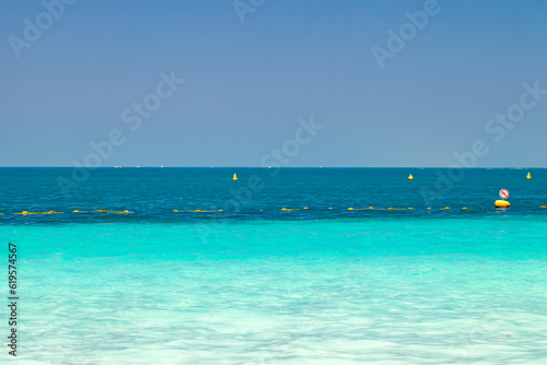 Fototapeta Naklejka Na Ścianę i Meble -  Sea with clear turquoise water and yellow protective buoys in clear day