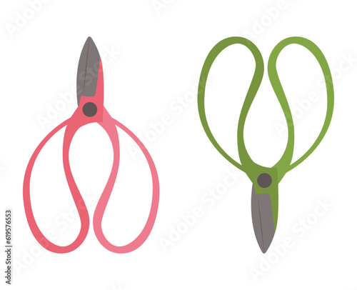 Two gardening scissors in pink and green colors. 
