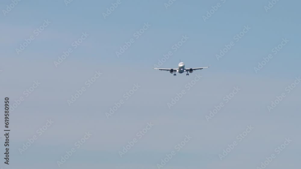 Plane approaching landing. Long shot of aircraft flies. Airplane high in the sky. Tourism and travel concept Plane approaching landing. Long shot of aircraft flies. Airplane high in the sky. Tourism and travel concept