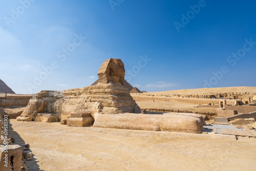 The Great Sphinx at the Giza pyramid complex   Giza necropolis is home to the Great Pyramid  the Pyramid of Khafre  and the Pyramid of Menkaure    in Cairo  Egypt.  Travel and history.