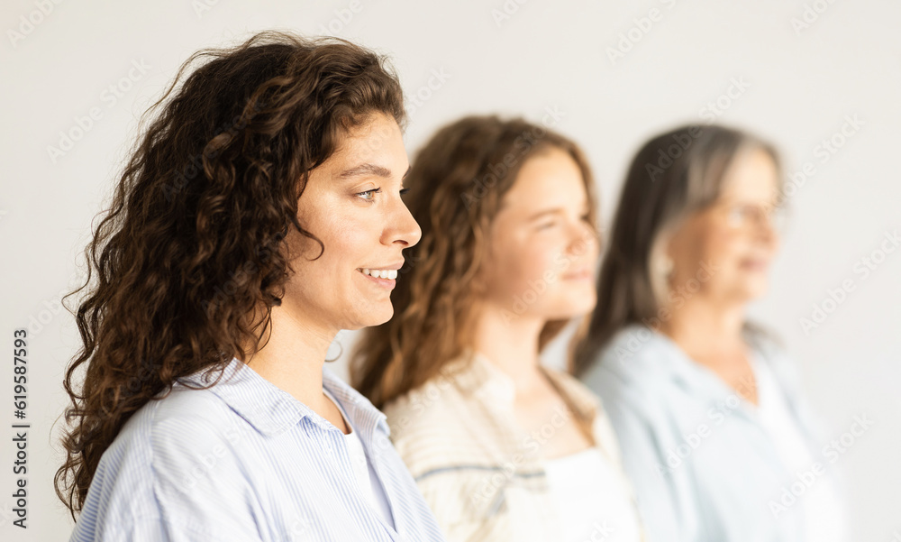 Positive caucasian mature, old and teen woman and girl, profile, isolated on white background, studio Positive caucasian mature, old and teen woman and girl, profile, isolated on white background, studio