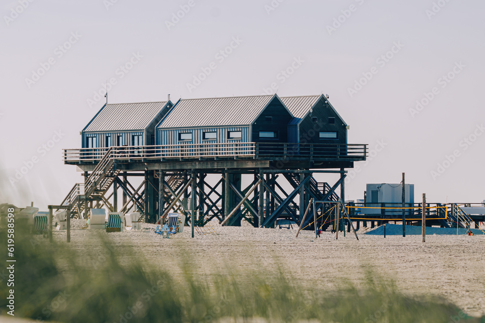 stilt houses on the beach in the North Sea, Germany