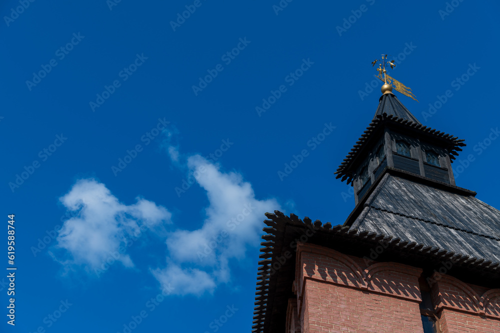 Old Tula Kremlin red brick wall and tower with wooden roof in sunny summer day. Clear blue sky with few clouds. Medieval architecture. Copy space for your text. Travel in Russia theme.