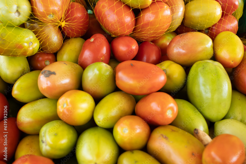 bowl full of various tomatoes and some packed in bags