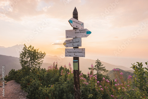 Route signs in the Tatra mountains at sunset.