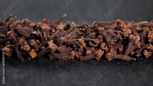 Spices dried cloves on a black background close-up for cooking. The kidneys contain the amount of essential oil which includes eugenol, acetylievgenol, as well as tannins, organic acids oleanolic acid photo