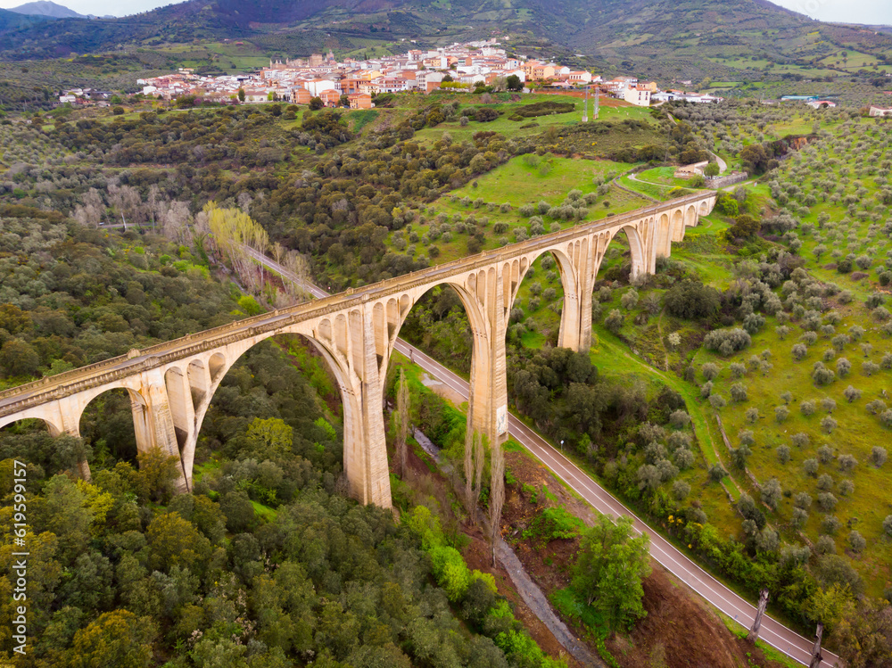 View of grand structure of arched viaduct located in picturesque area near Spanish township of Guadalupe in Extremadura community on spring day