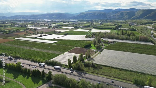 Loriol sur Drome - France, 6 June 2023: Panoramic aerial view of traffic on the sunny highway (Autoroute du Soleil A7) in the south of France, in the Drome region. photo