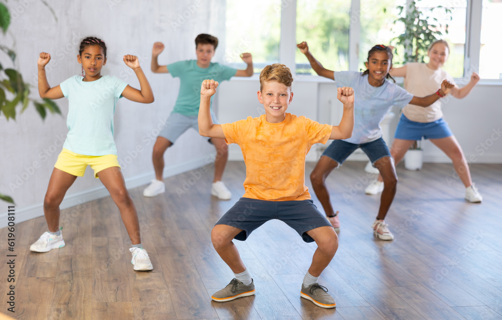 Active preteen children practicing Hip-hop dance in training hall during dancing classes