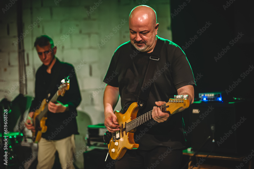 Obraz premium Bass and electric guitar music band artist have solo live performance on a stage. Repetition and practice