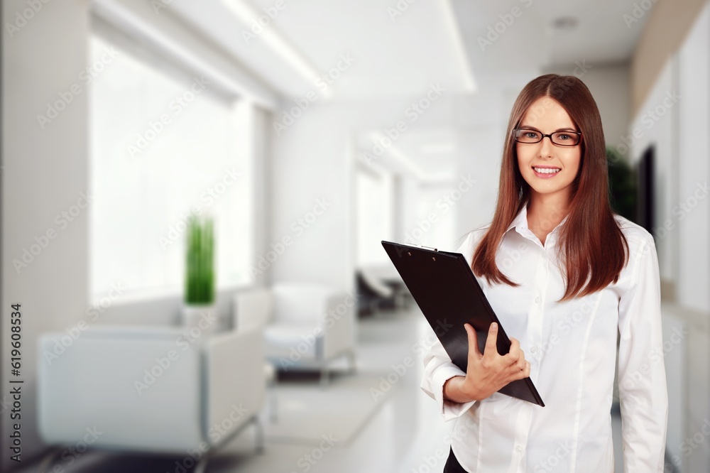 Young businesswoman hold clipboard in the office Young businesswoman hold clipboard in the office