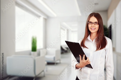 Young businesswoman hold clipboard in the office