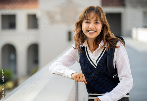 Portrait of young multiethnic Pacific Islander smiling student with backpack on college or university campus