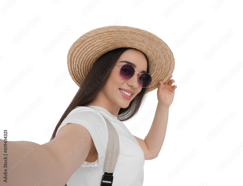 Smiling young woman in sunglasses and straw hat taking selfie on white background Smiling young woman in sunglasses and straw hat taking selfie on white background