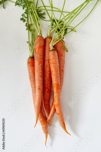 Overhead view of bunch of carrot against white background photo