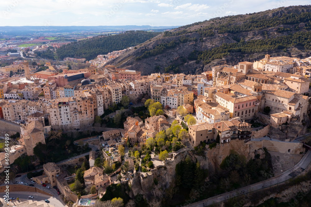 Picturesque view from drone of historic district of Cuenca city on steep spur above deep gorges of Jucar and Huecar rivers on sunny spring day, Spain