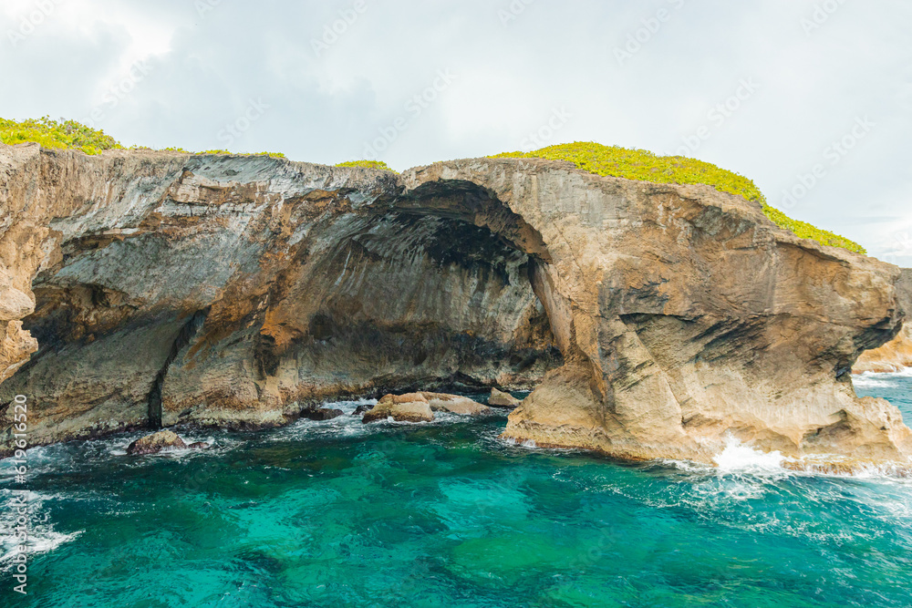 Cueva del indio cave rock formation  landscape around turquoise water in a cloudy day from puerto rico in arecibo