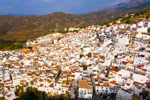 Aerial view of Competa, small picturesque town in foothills of La Maroma mountain on sunny fall day, Spain © JackF