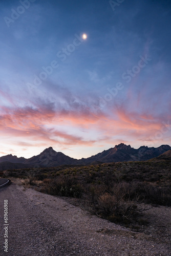 Moon Sits High In The Sky Over Chisos Mountains At Sunrise