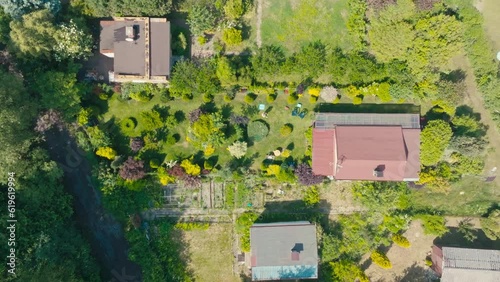 Drone view of allotment gardens, a resting place for people outside the city. View from the air on people resting on the plots.