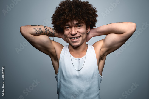 Cheerful tough man with raised arms