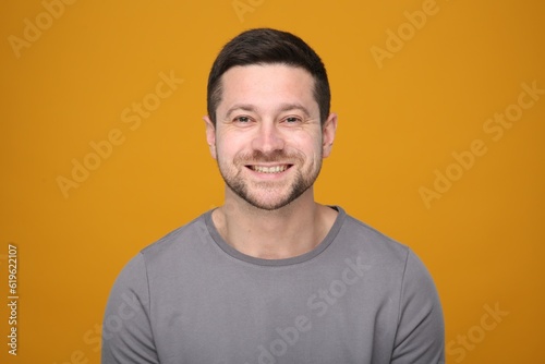 Portrait of handsome man on orange background
