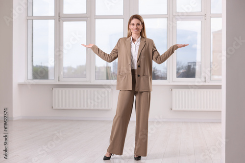 Happy real estate agent showing new apartment