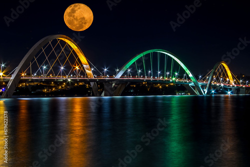 Big Glowing Orange Moon rising over JK Bridge in Brasilia, Brazil © Marcos