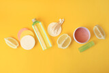 Lemon face cleanser. Fresh citrus fruits and personal care products on yellow background, flat lay