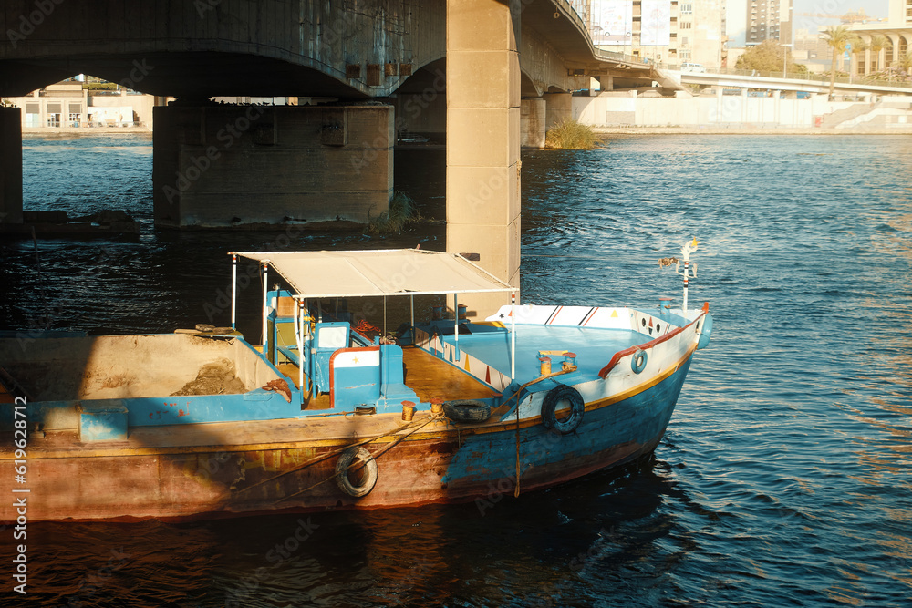 Egypt, Cairo - Boat in the Nile River under Bridge, Downtown Cairo.