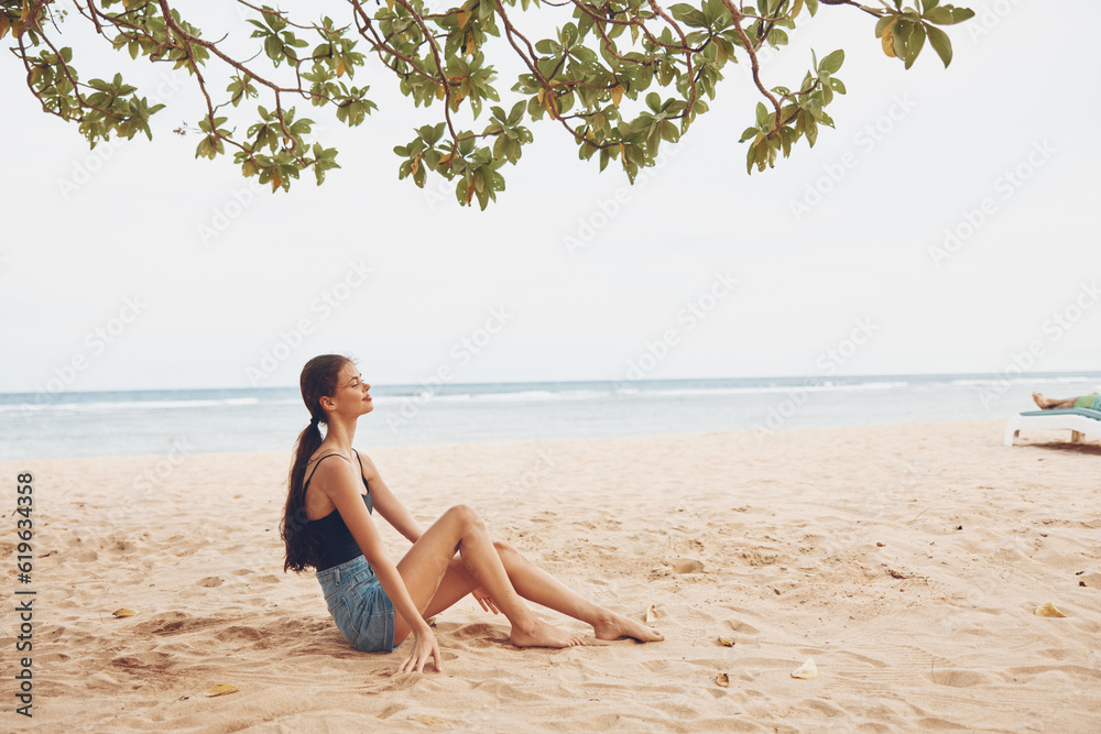 Obraz premium body woman sea beach sand sitting smile travel nature vacation freedom