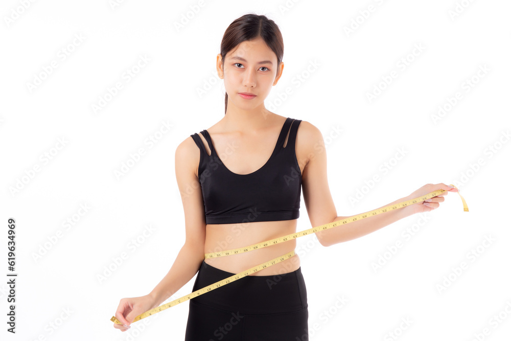 Portrait beautiful young asian woman measure tape with waist for weightloss with satisfied isolated white background, female in sportswear slimming shape with workout, sport and health care concept. Portrait beautiful young asian woman measure tape with waist for weightloss with satisfied isolated white background, female in sportswear slimming shape with workout, sport and health care concept.