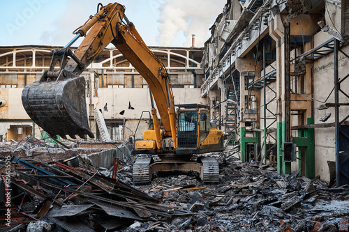 Hydraulic excavator works with debris at demolition site