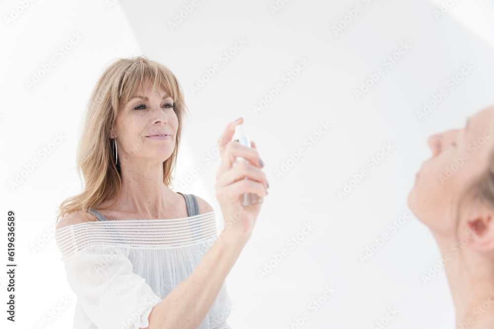 Photograph of a beautiful middle aged woman taken for a day spa photographed on white. Photograph of a beautiful middle aged woman taken for a day spa photographed on white.