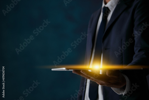 Half Body Businessman Hold Tablet and Flare Light in Dark Tone