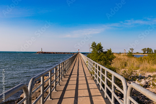 Center view of Boardwalk with metal railings centered down Lake Michigan  © Andrew