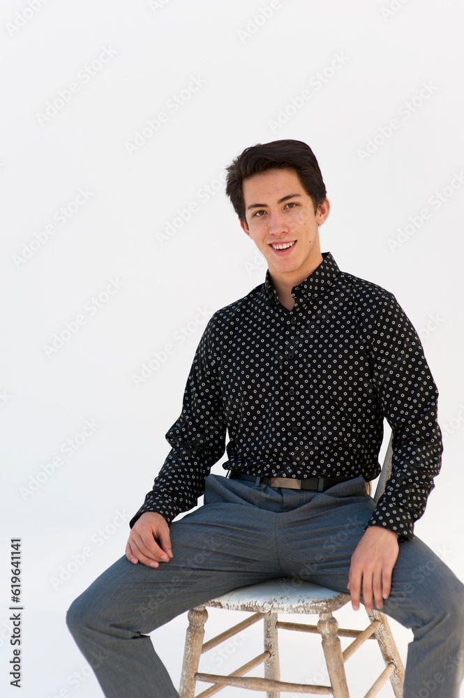 Headshot portrait photography of a young man dressed for  success photographed on a white background. 