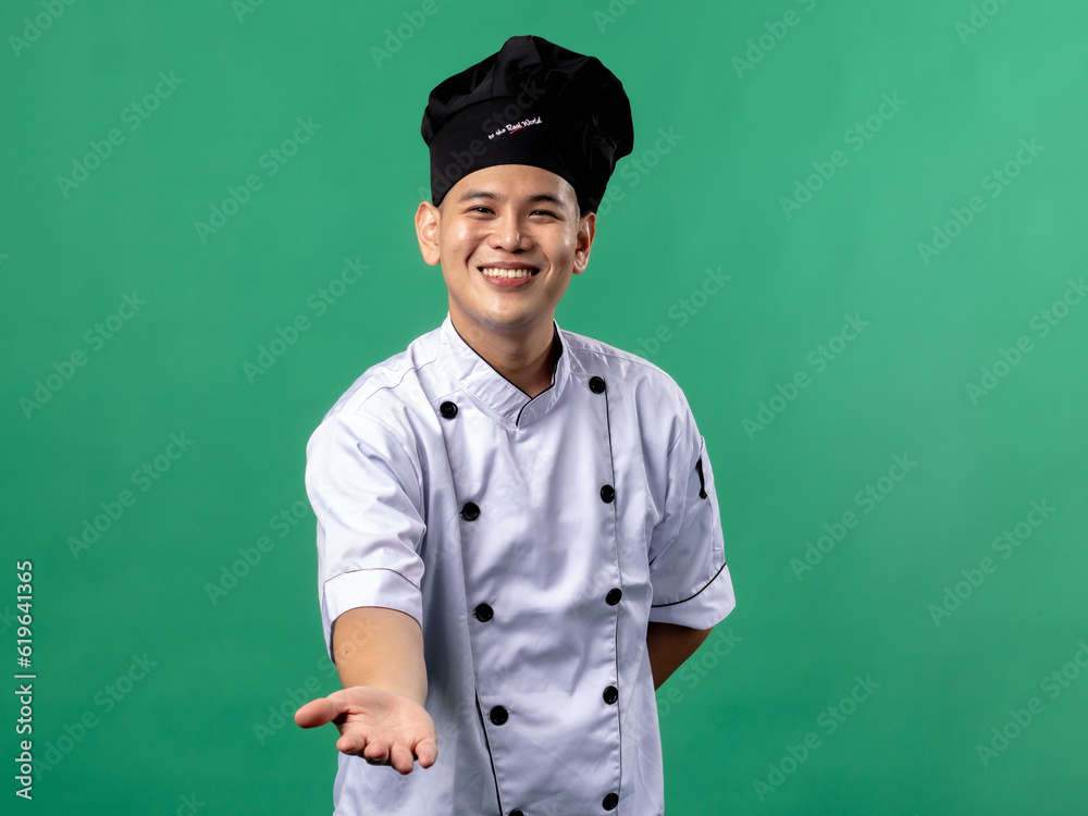 A portrait of an Indonesian Asian man wearing a chef's uniform and a chef's hat, seen posing, isolated with a green background. A portrait of an Indonesian Asian man wearing a chef's uniform and a chef's hat, seen posing, isolated with a green background.