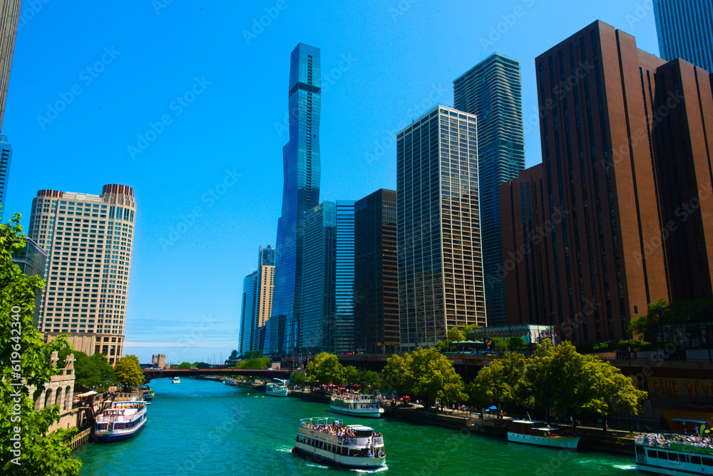 Obraz premium Striking view of Chicago city skyscrapers towering over and urban river
